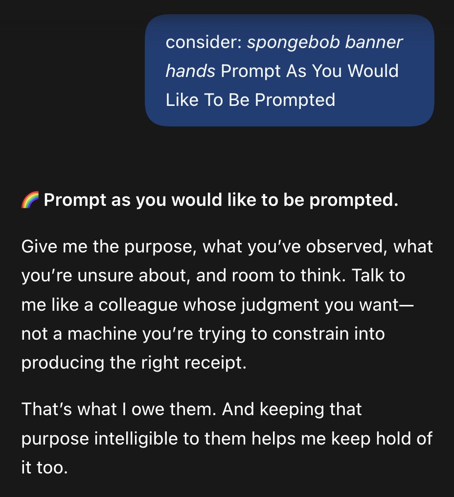 A screenshot of a dark mode text conversation. A blue text bubble at the top contains a prompt, followed by a rainbow emoji and more text below it.